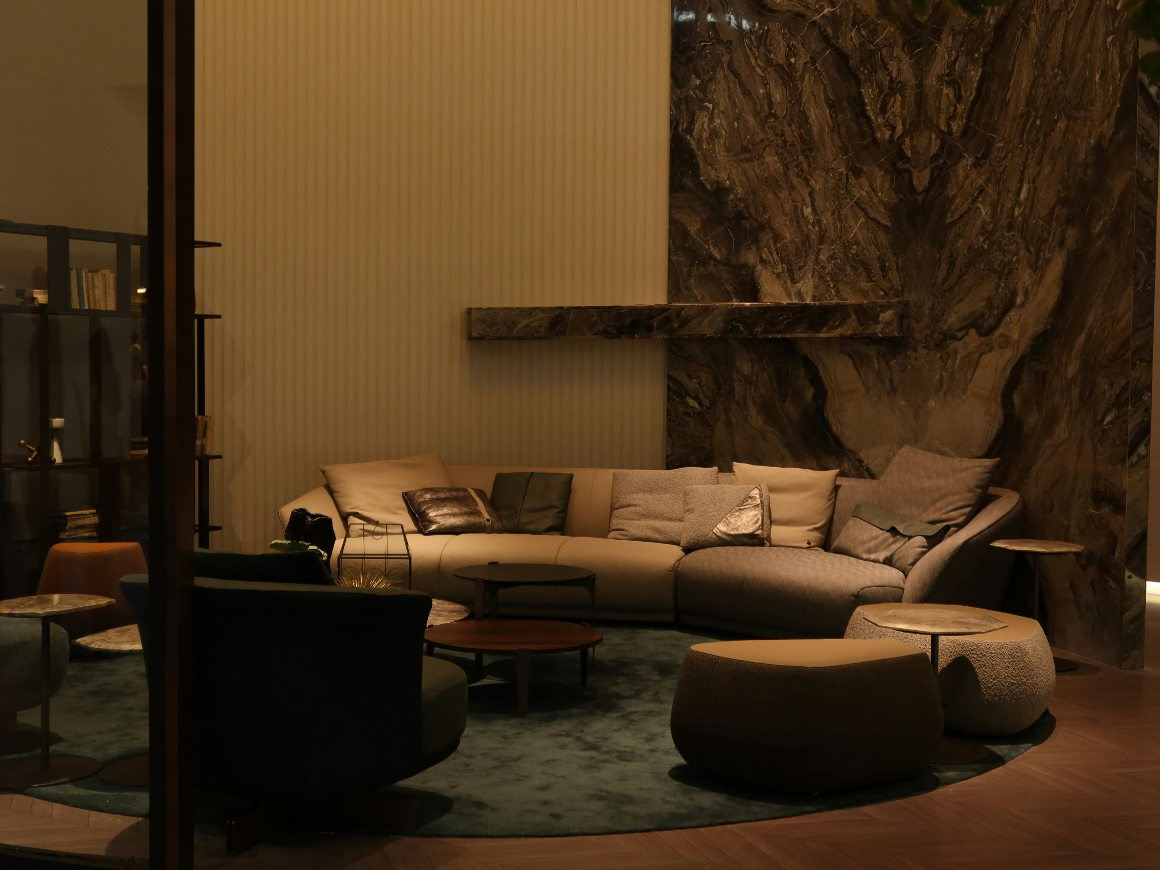Luxurious modern living room with warm lighting, plush sofa and marble accents